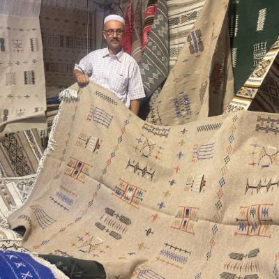 Alžírčan predávajúci koberce.