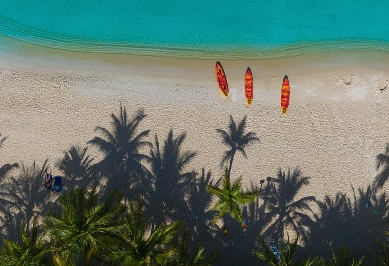 Piesková pláž a palmy na ostrove Phu Quoc.