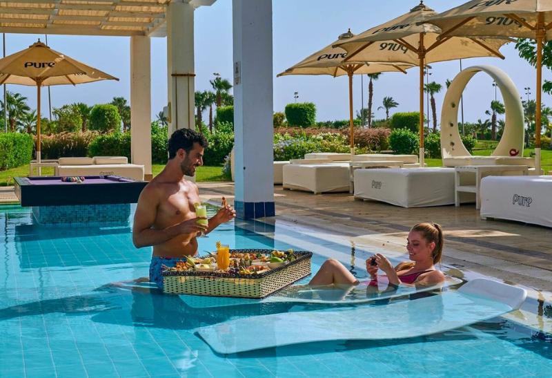 Pár v bazéne s raňajkami hotela Steigenberger Pure Lifestyle v Egypte.