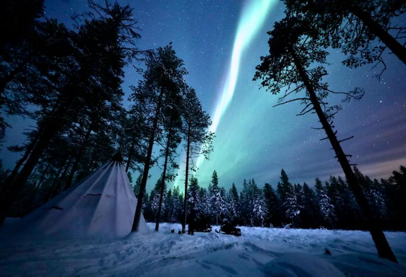 Polárna žiara v tme vo Fínsku pri Rovaniemi.