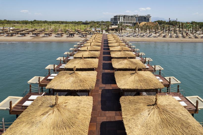 Hotel Cullinan Belek s mólom, plážou a budovou hotela v pozadí.