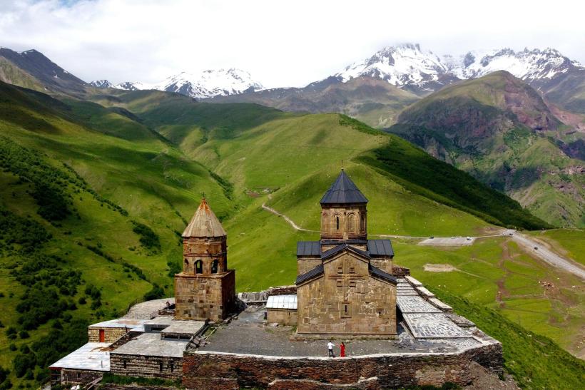 Kostol a mohutný Kaukaz v Kazbegi.