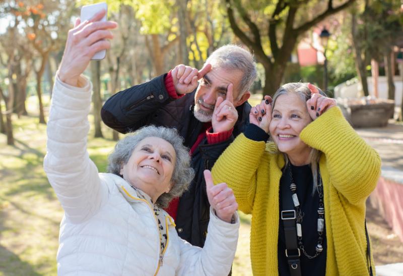 Veselá skupina si robí selfie foto.