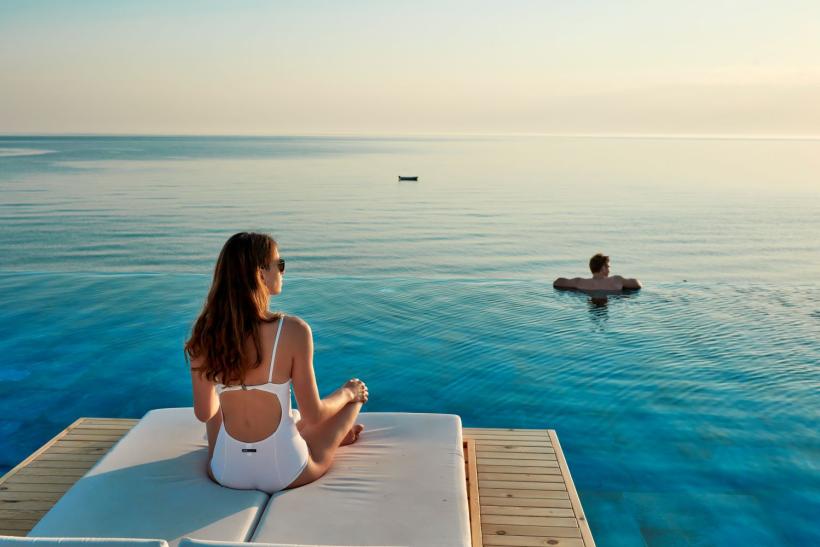 párik v infinity pool počas romantickej dovolenky