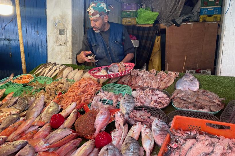 Muž ponúka čerstvé ryby na trhu v Maroku.