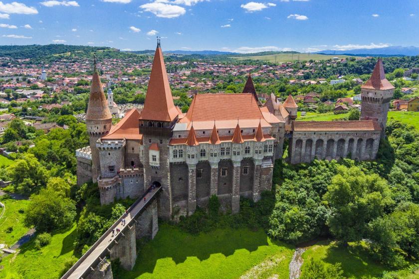 Zámok Hunedoara a zelený park.