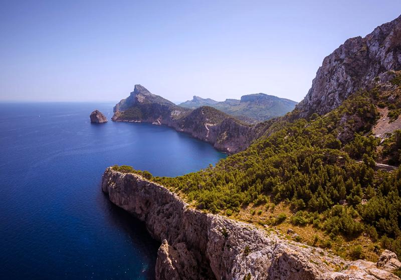 Skalné pobrežie pokryté zelenými stromami v Cap de Formentor, Malorka. Foto: unsplash.com