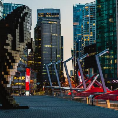 Digitálna orca v centre mesta Vancouver a okolité moderné budovy.